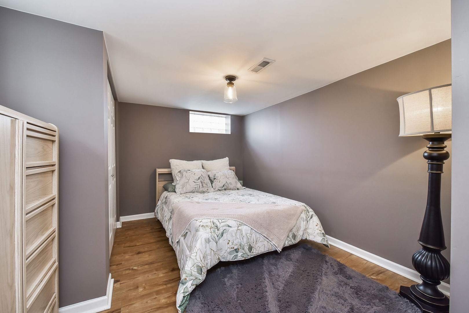 1500 Lee Boulevard Berkeley, IL 60163 - Photo 18 of 22 a bedroom with a bed and wooden floor