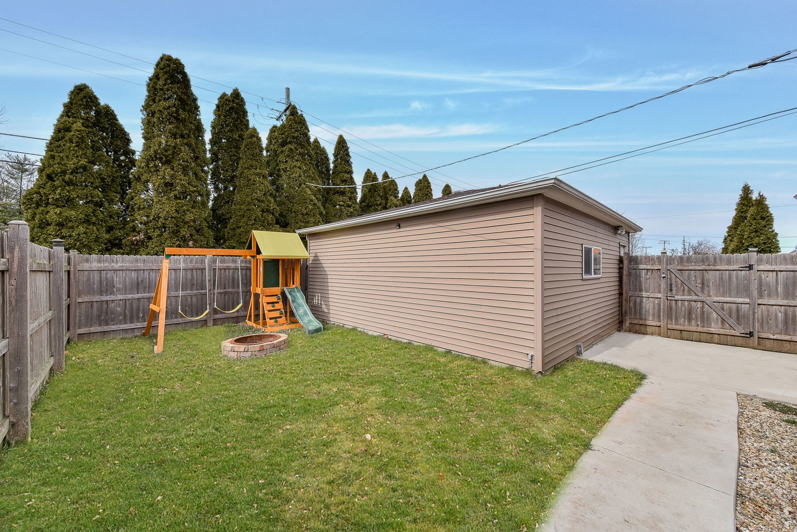 1500 Lee Boulevard Berkeley, IL 60163 - Photo 20 of 22 a view of a backyard with plants and a slide