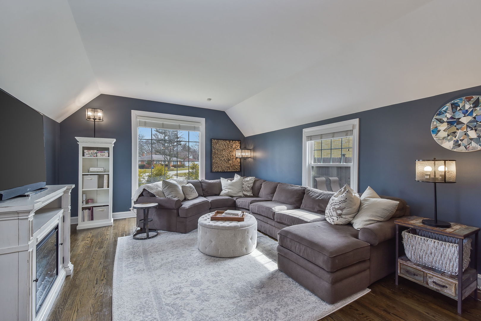 1500 Lee Boulevard Berkeley, IL 60163 - Photo 3 of 22 a living room with furniture a large window and a flat screen tv