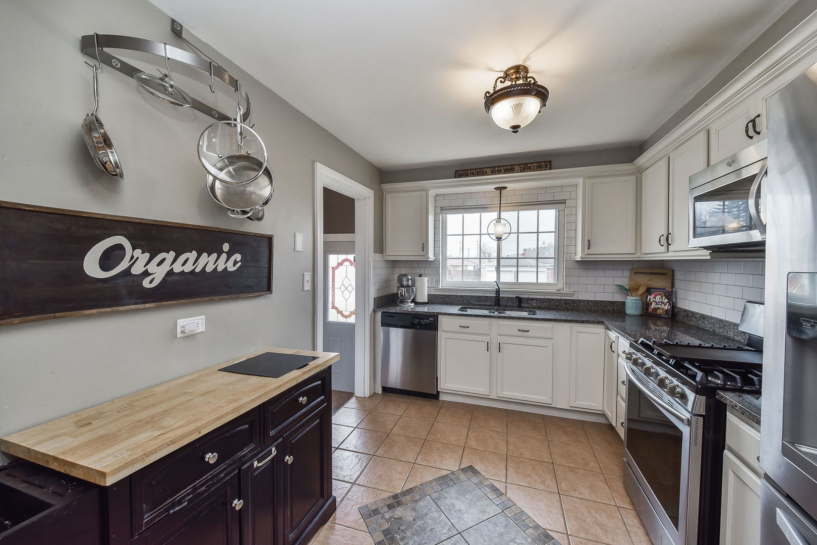 1500 Lee Boulevard Berkeley, IL 60163 - Photo 7 of 22 a kitchen with stainless steel appliances granite countertop a stove a sink and a microwave