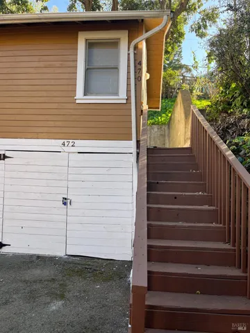 a view of a house with wooden fence and two windows