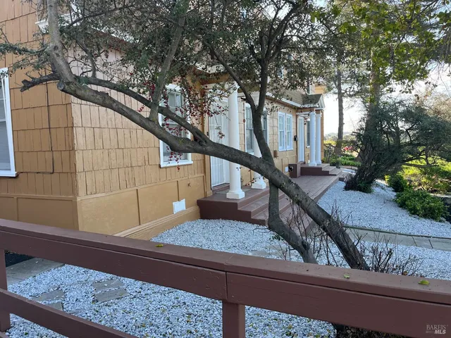 a view of balcony with wooden floor and tree