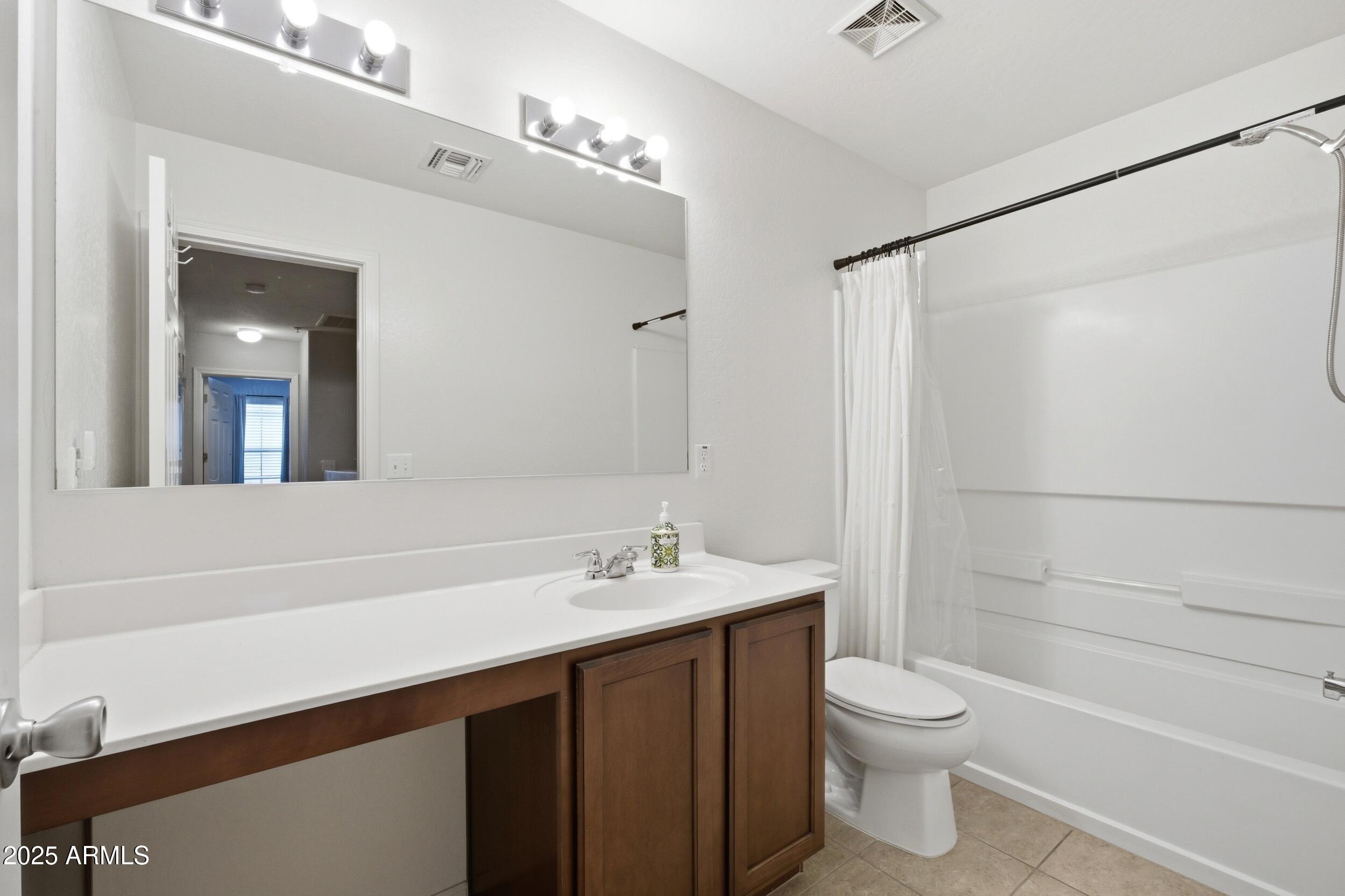 1255 South Rialto, Unit 162 Mesa, AZ 85209 - Photo 14 of 27 a bathroom with a sink a toilet and shower
