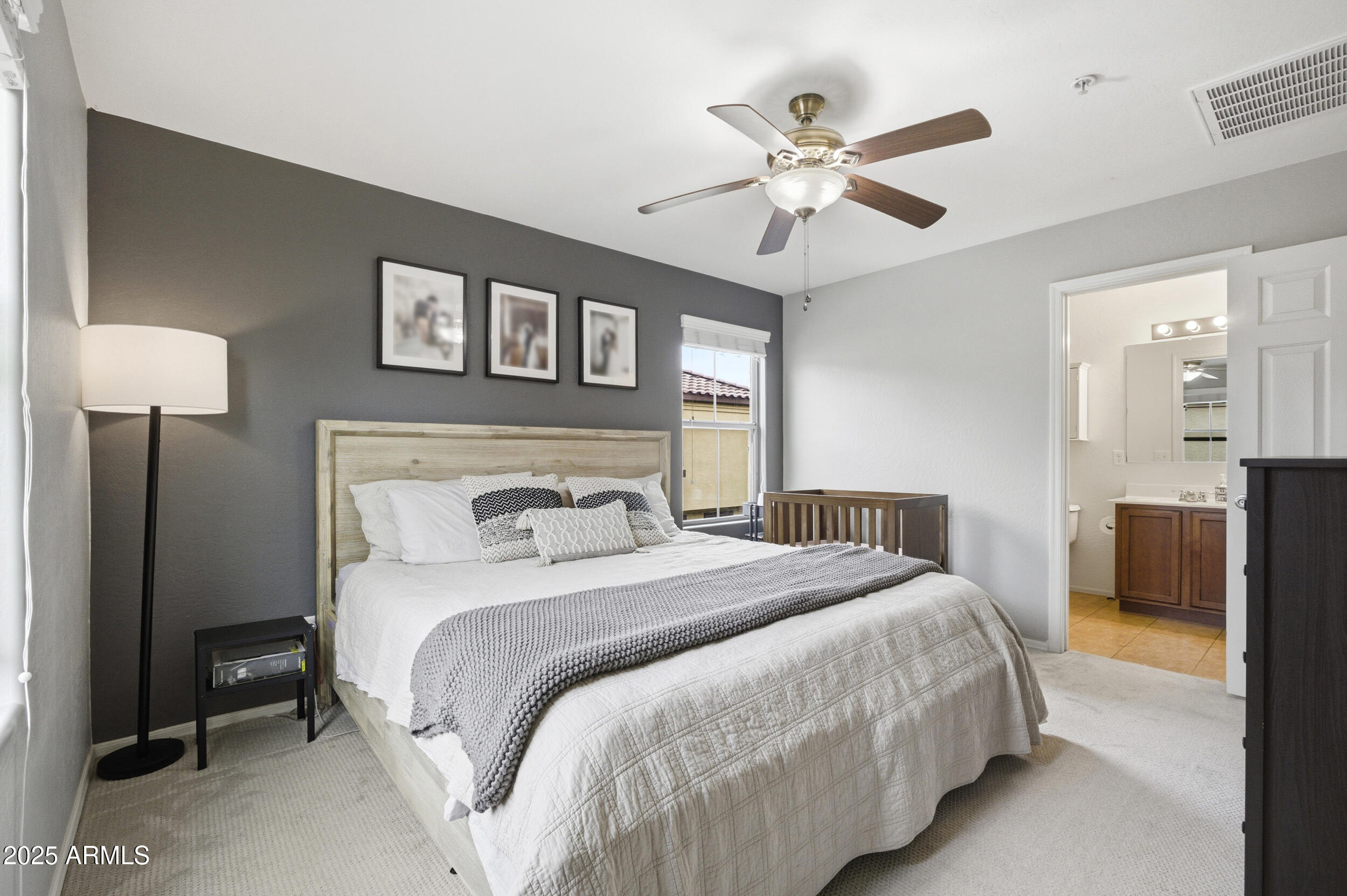 1255 South Rialto, Unit 162 Mesa, AZ 85209 - Photo 19 of 27 a bedroom with a large bed and a chandelier