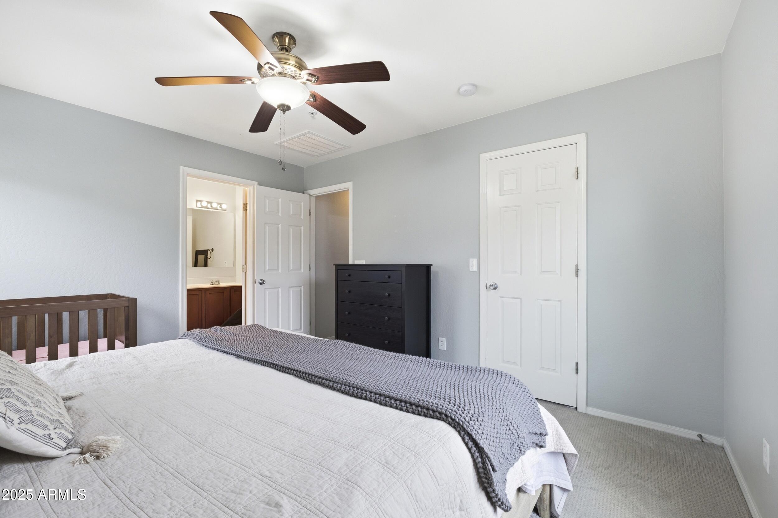 1255 South Rialto, Unit 162 Mesa, AZ 85209 - Photo 20 of 27 a bedroom with a bed and a ceiling fan