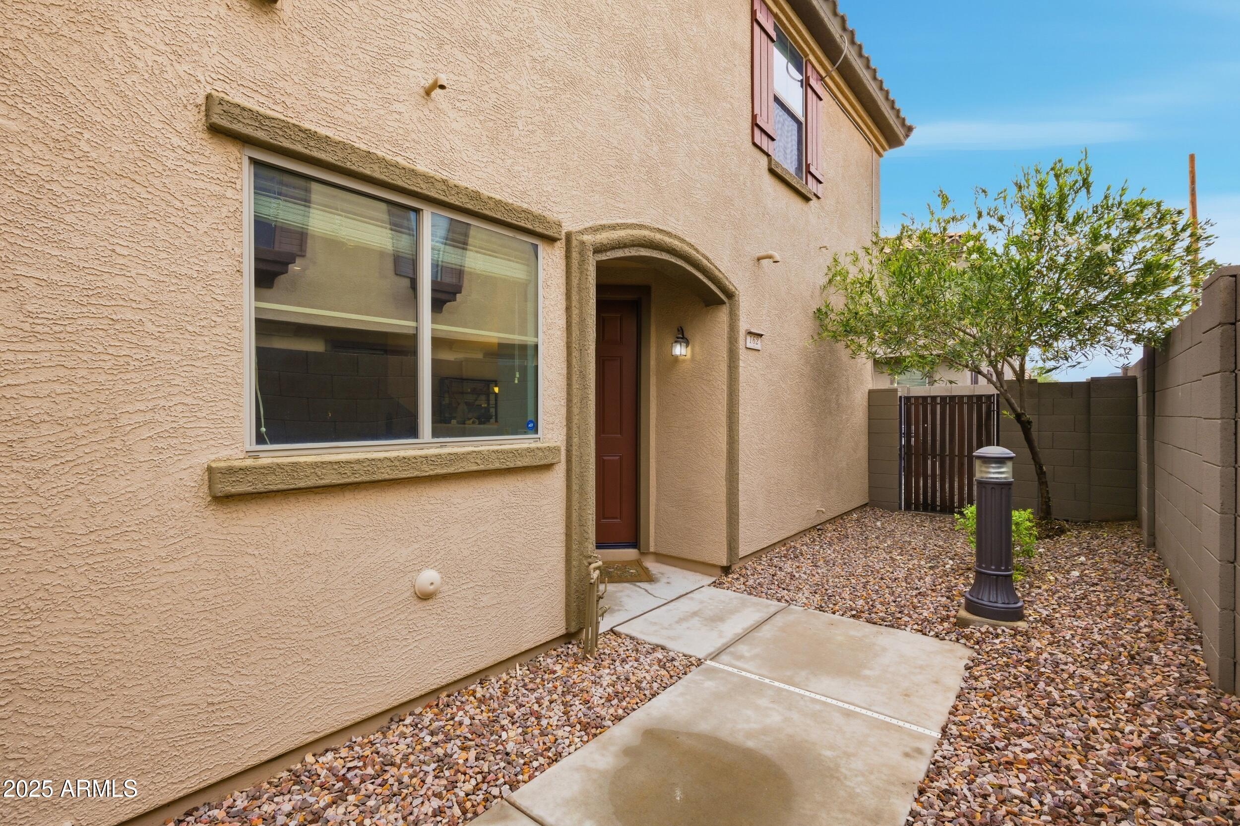 1255 South Rialto, Unit 162 Mesa, AZ 85209 - Photo 26 of 27 a front view of a house with a yard