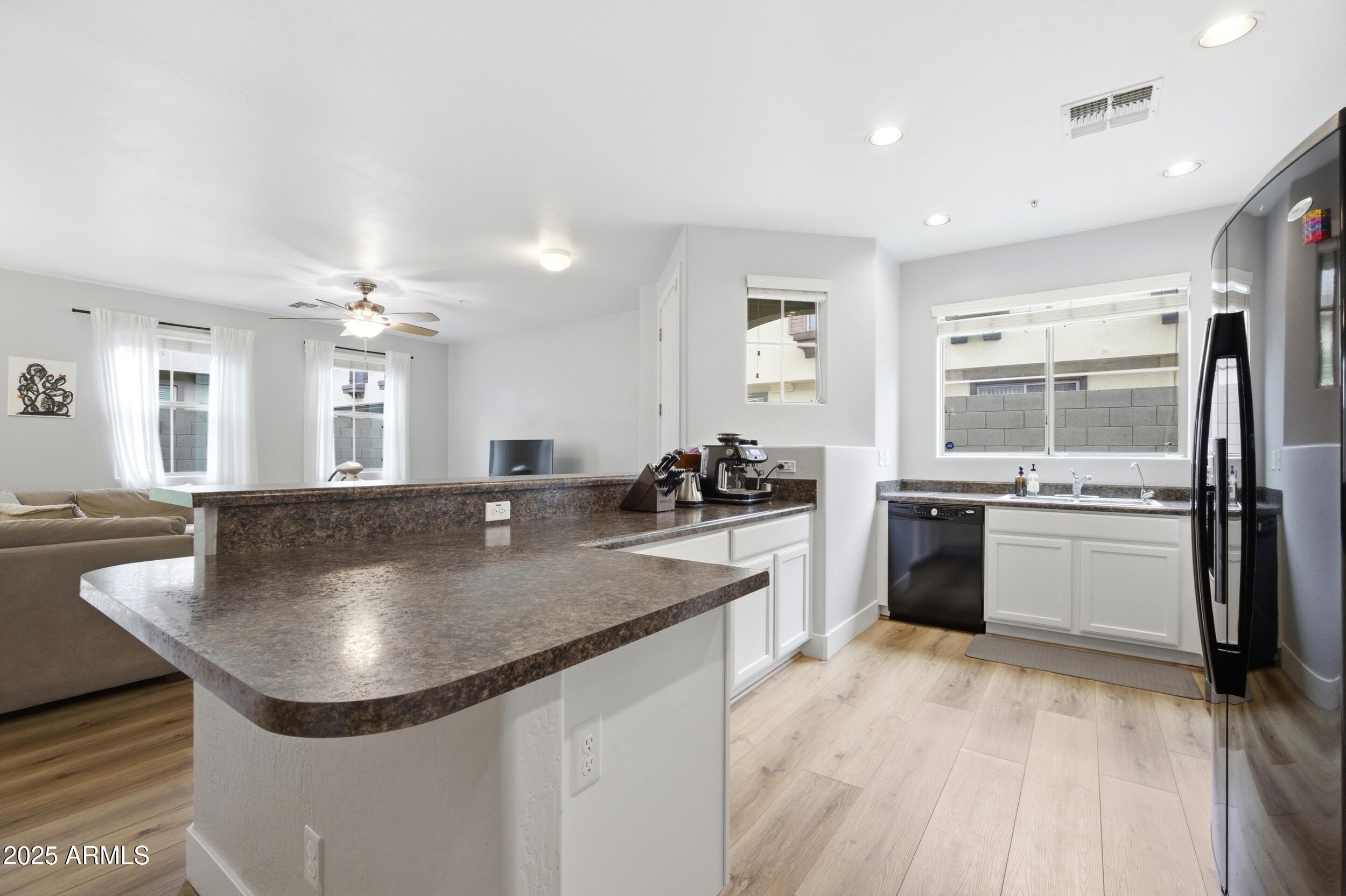 1255 South Rialto, Unit 162 Mesa, AZ 85209 - Photo 9 of 27 a kitchen with stainless steel appliances granite countertop a sink a counter top space and cabinets