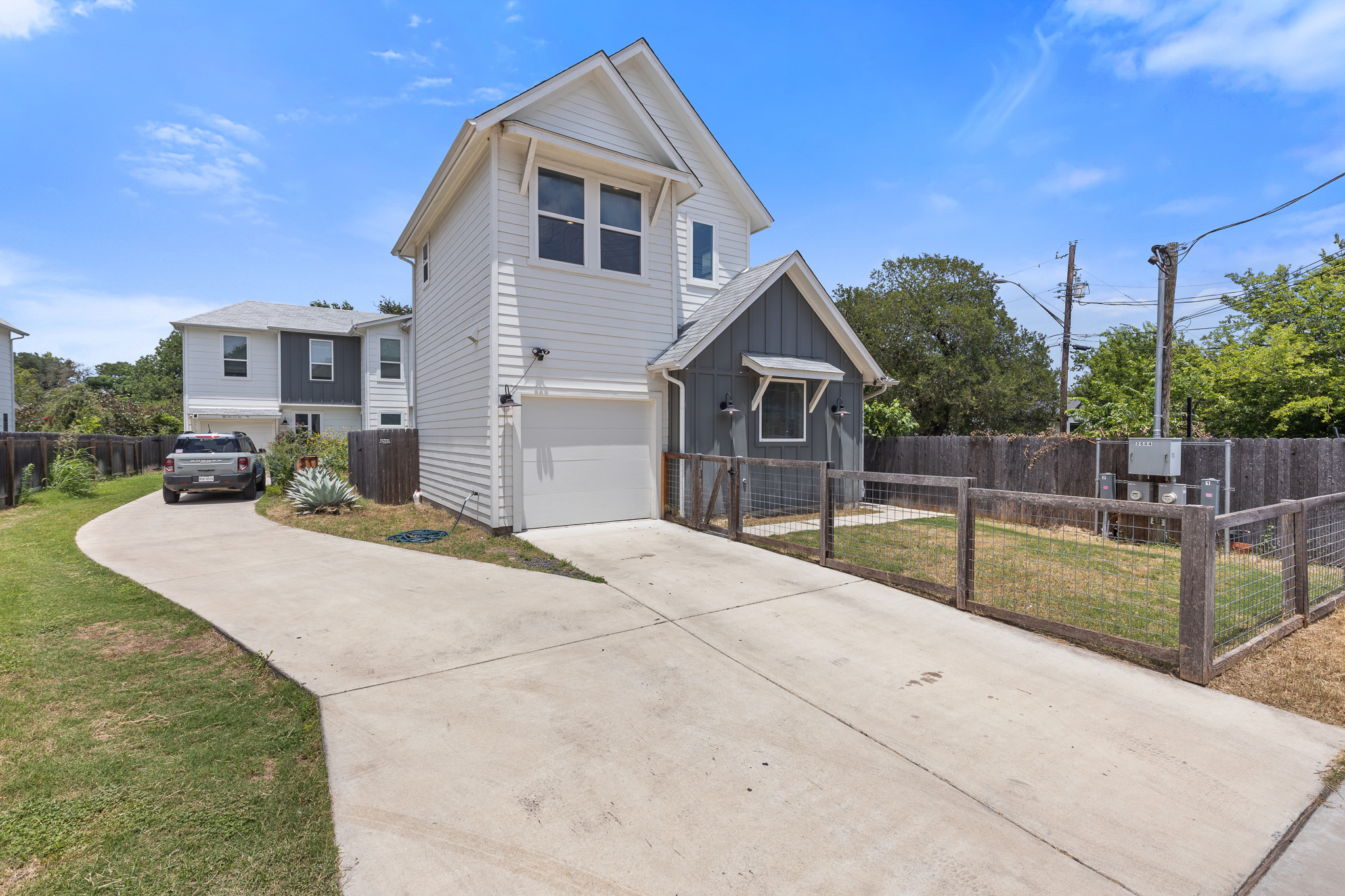 2604 Wheless Lane, Unit 1 Austin, TX 78723 - Photo 2 of 38 Driveway and attached garage provide convenient, covered parking and storage.