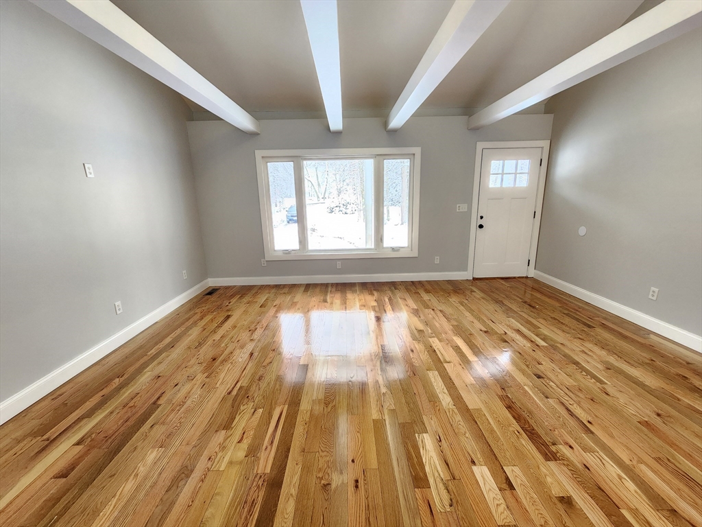 405 Queen Lake Road Phillipston, MA 01331 - Photo 11 of 25 a view of empty room with wooden floor and fan