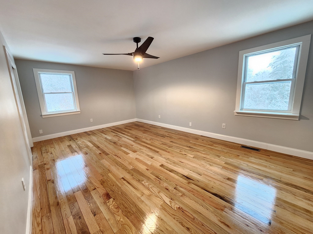 405 Queen Lake Road Phillipston, MA 01331 - Photo 13 of 25 a view of empty room with wooden floor and fan