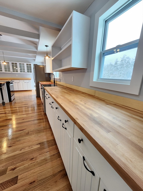 405 Queen Lake Road Phillipston, MA 01331 - Photo 17 of 25 a view of a kitchen with wooden floor and a large window
