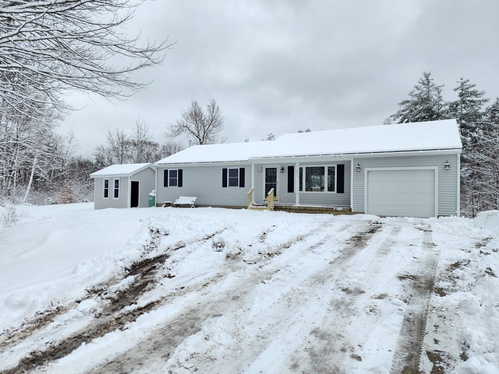 405 Queen Lake Road Phillipston, MA 01331 - Photo 24 of 25 a front view of a house with a yard covered in snow