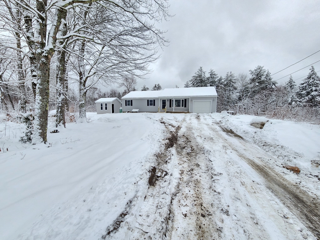 405 Queen Lake Road Phillipston, MA 01331 - Photo 25 of 25 a view of a large white house with a yard covered in snow