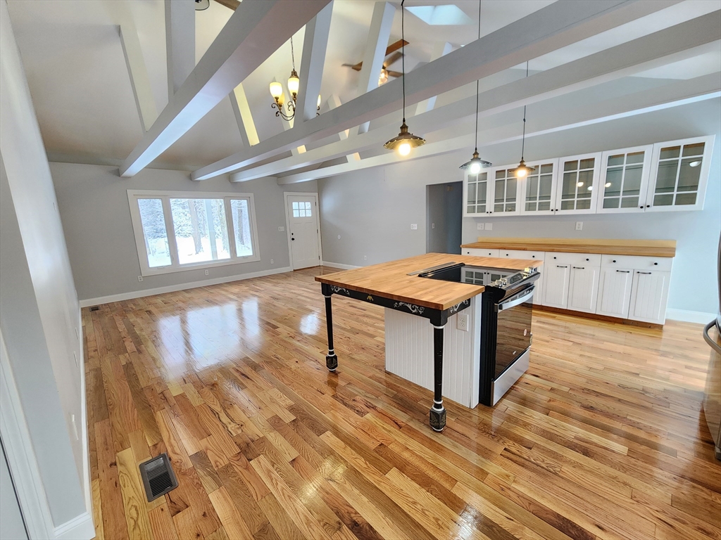405 Queen Lake Road Phillipston, MA 01331 - Photo 5 of 25 a kitchen with stainless steel appliances granite countertop a stove and a wooden floors