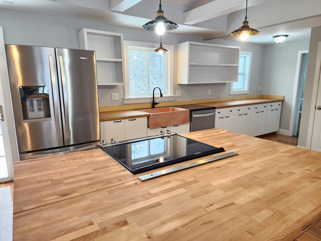 405 Queen Lake Road Phillipston, MA 01331 - Photo 8 of 25 a kitchen with stainless steel appliances granite countertop a refrigerator a sink and a stove