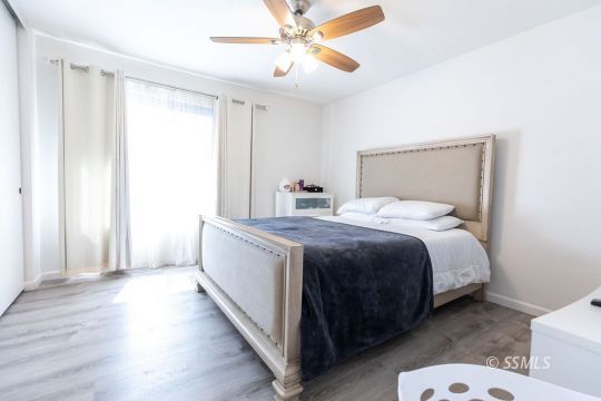 400 Tepatitlan Court Ridgecrest, CA 93555 - Photo 19 of 35 a bedroom with a bed and a chandelier