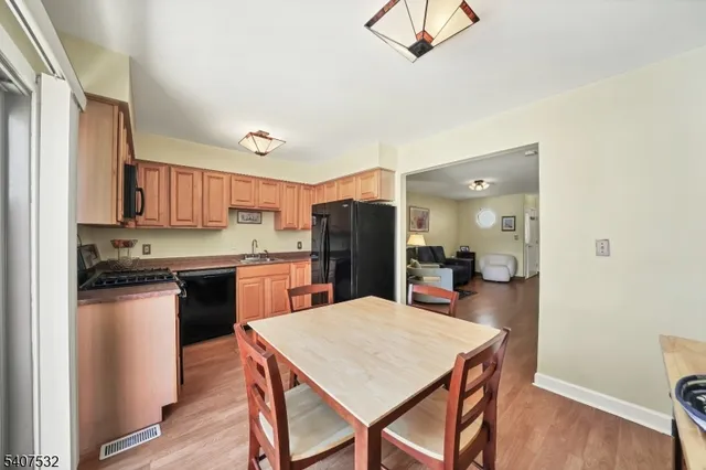a kitchen with a table and refrigerator