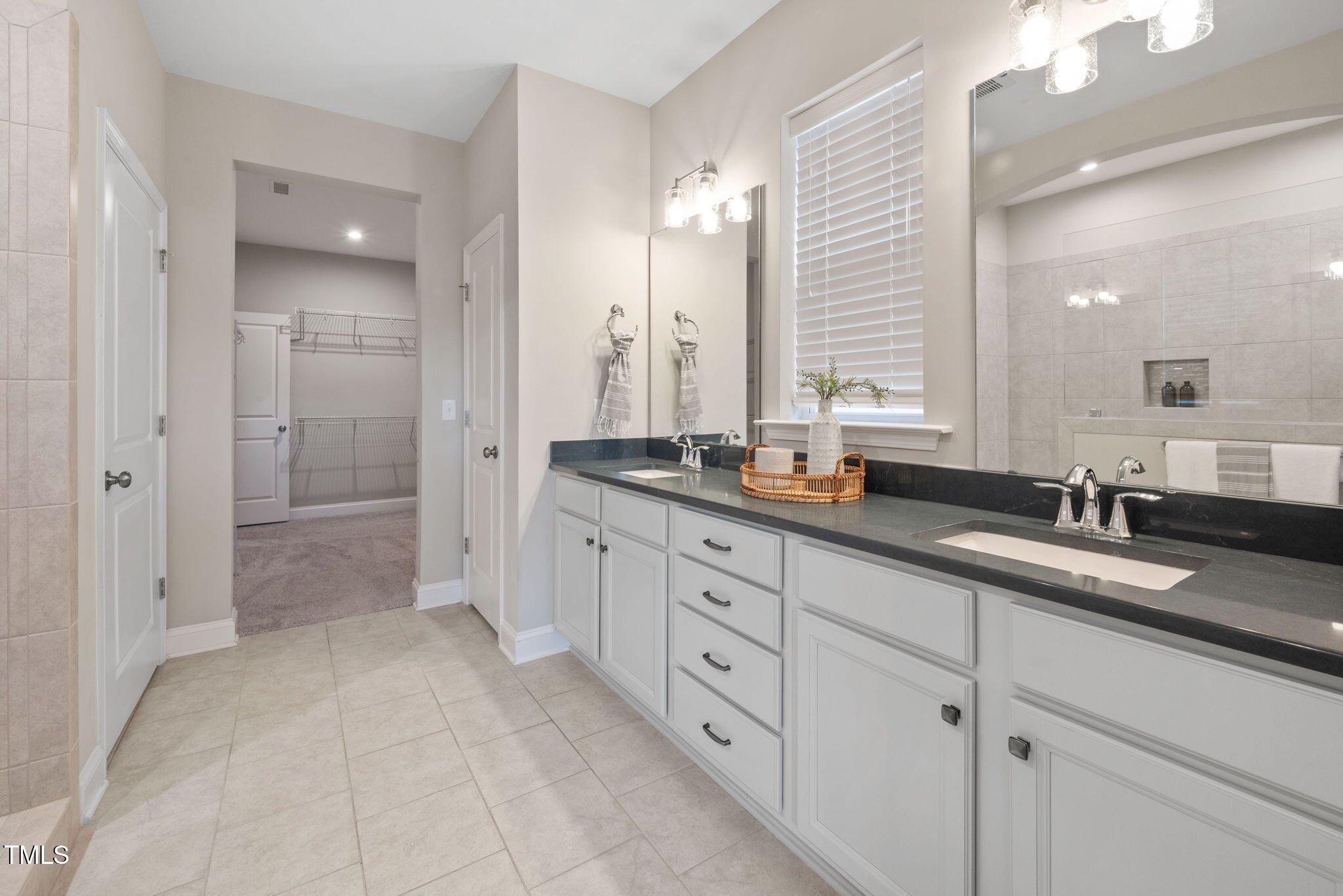 1821 Cypress Cove Drive Wendell, NC 27591 - Photo 17 of 31 a spacious bathroom with double sink and a mirror