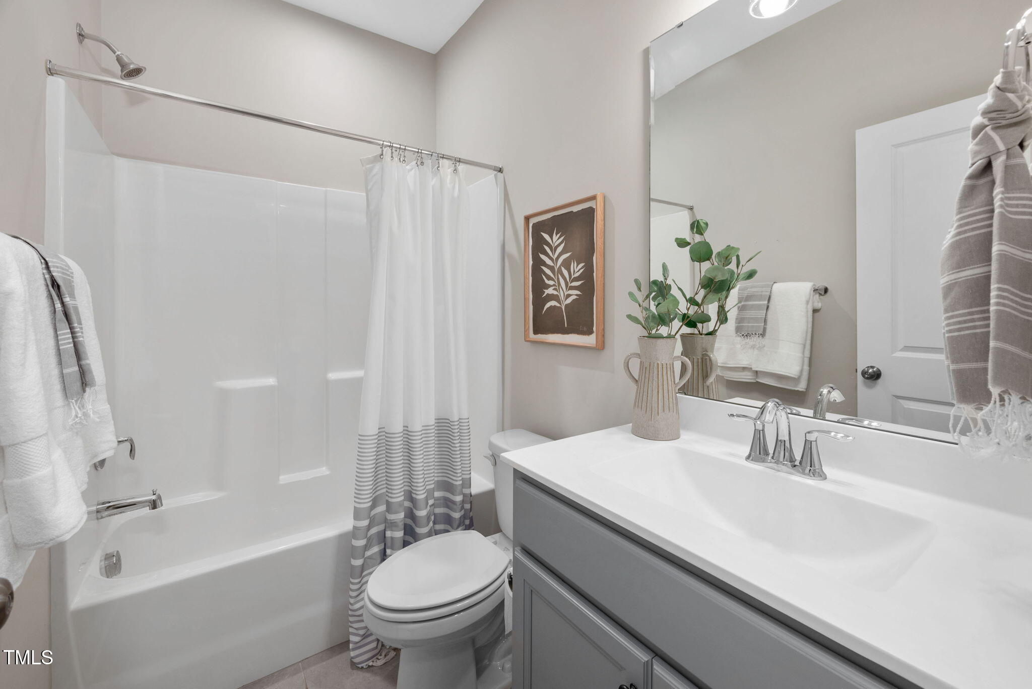 1821 Cypress Cove Drive Wendell, NC 27591 - Photo 24 of 31 a bathroom with a sink a toilet a mirror a bathtub and shower