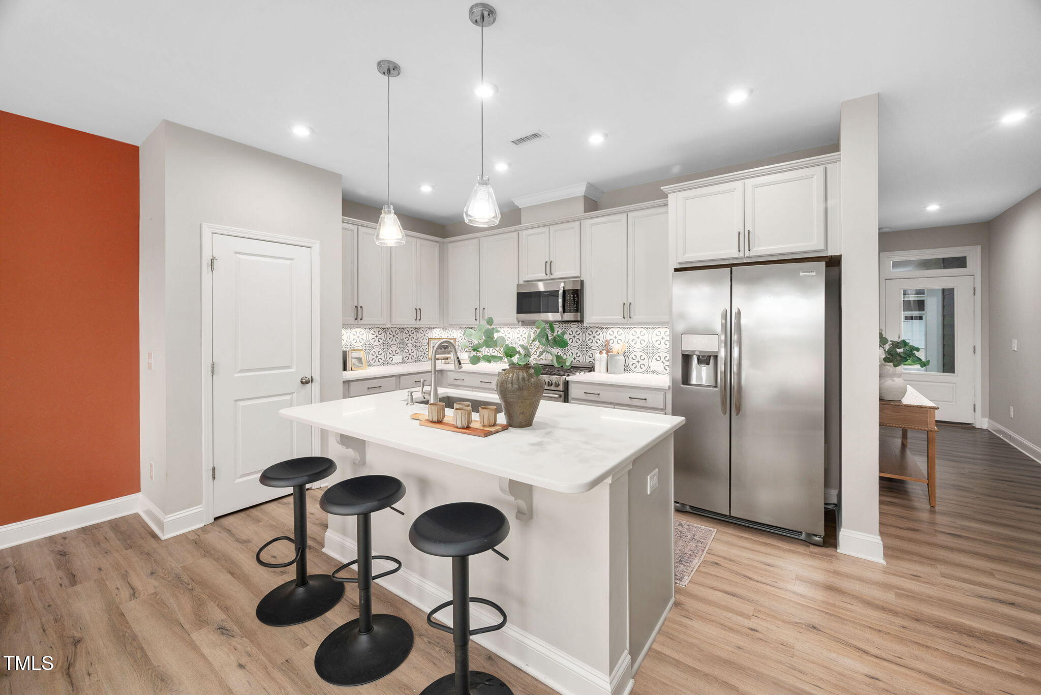 1821 Cypress Cove Drive Wendell, NC 27591 - Photo 5 of 31 a kitchen with a dining table cabinets appliances and wooden floor