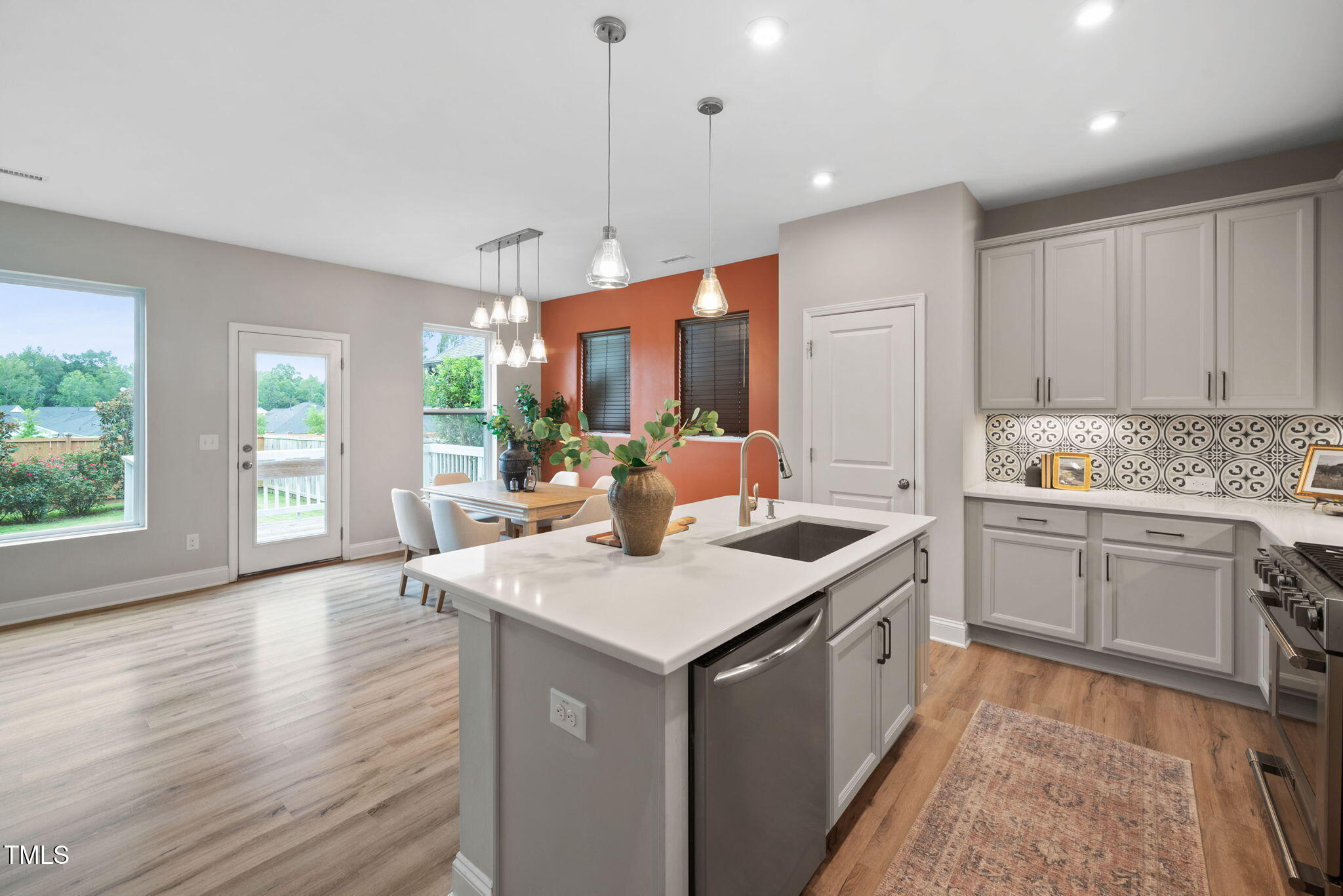 1821 Cypress Cove Drive Wendell, NC 27591 - Photo 8 of 31 a open kitchen with a sink stove and wooden cabinets