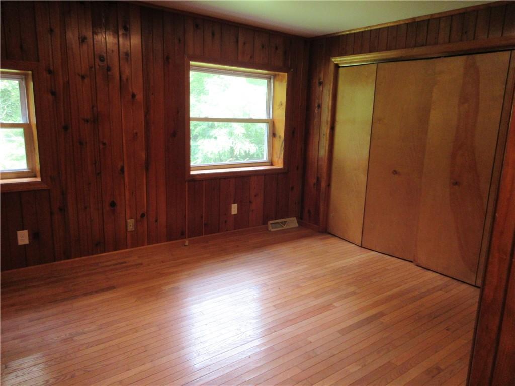 119 Shaffer Road Beaver Falls, PA 15010 - Photo 13 of 20 an empty room with wooden floor and windows with curtains