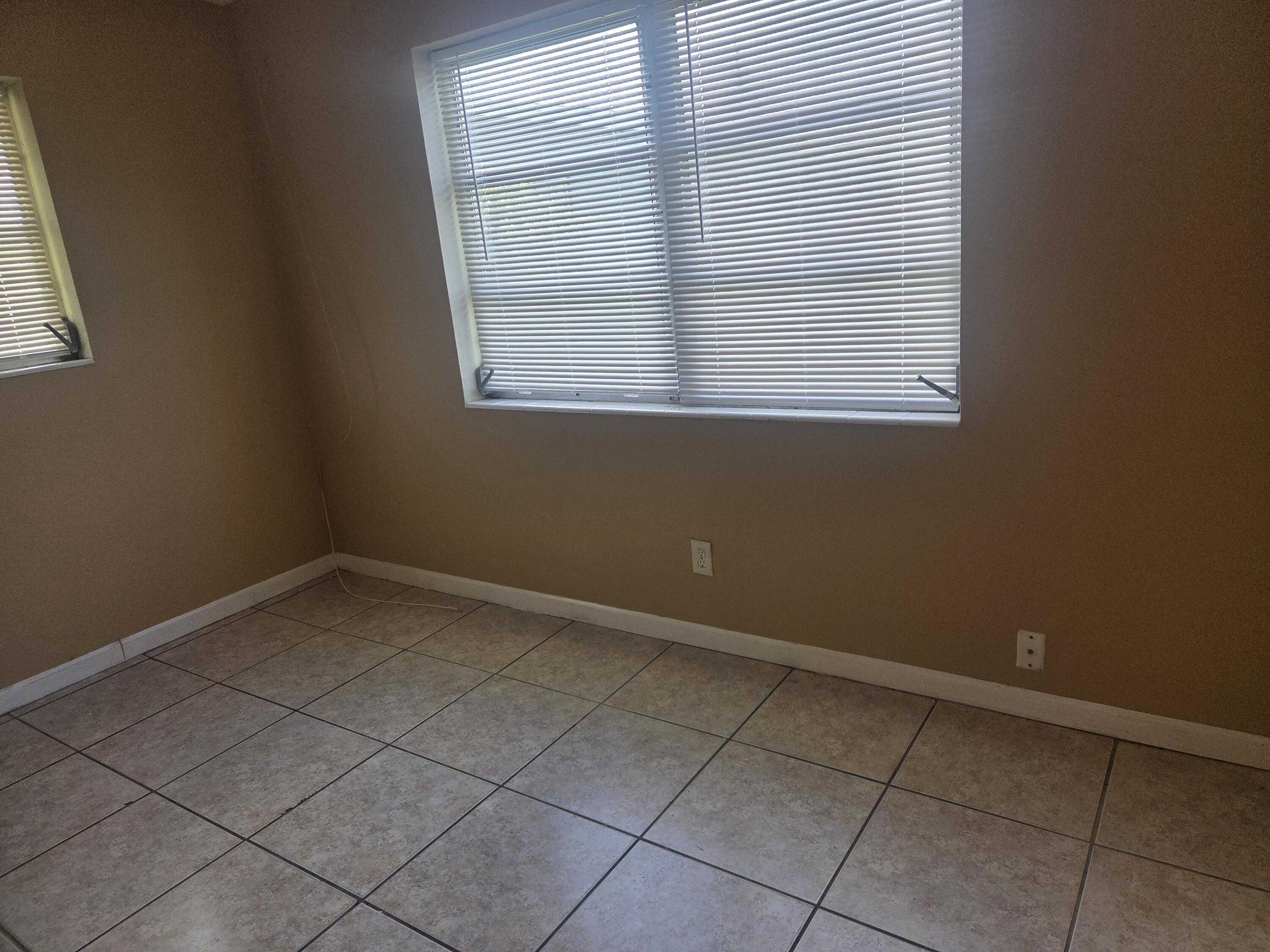 1509 Pine Tree Court Riviera Beach, FL 33404 - Photo 11 of 17 an empty room with a window