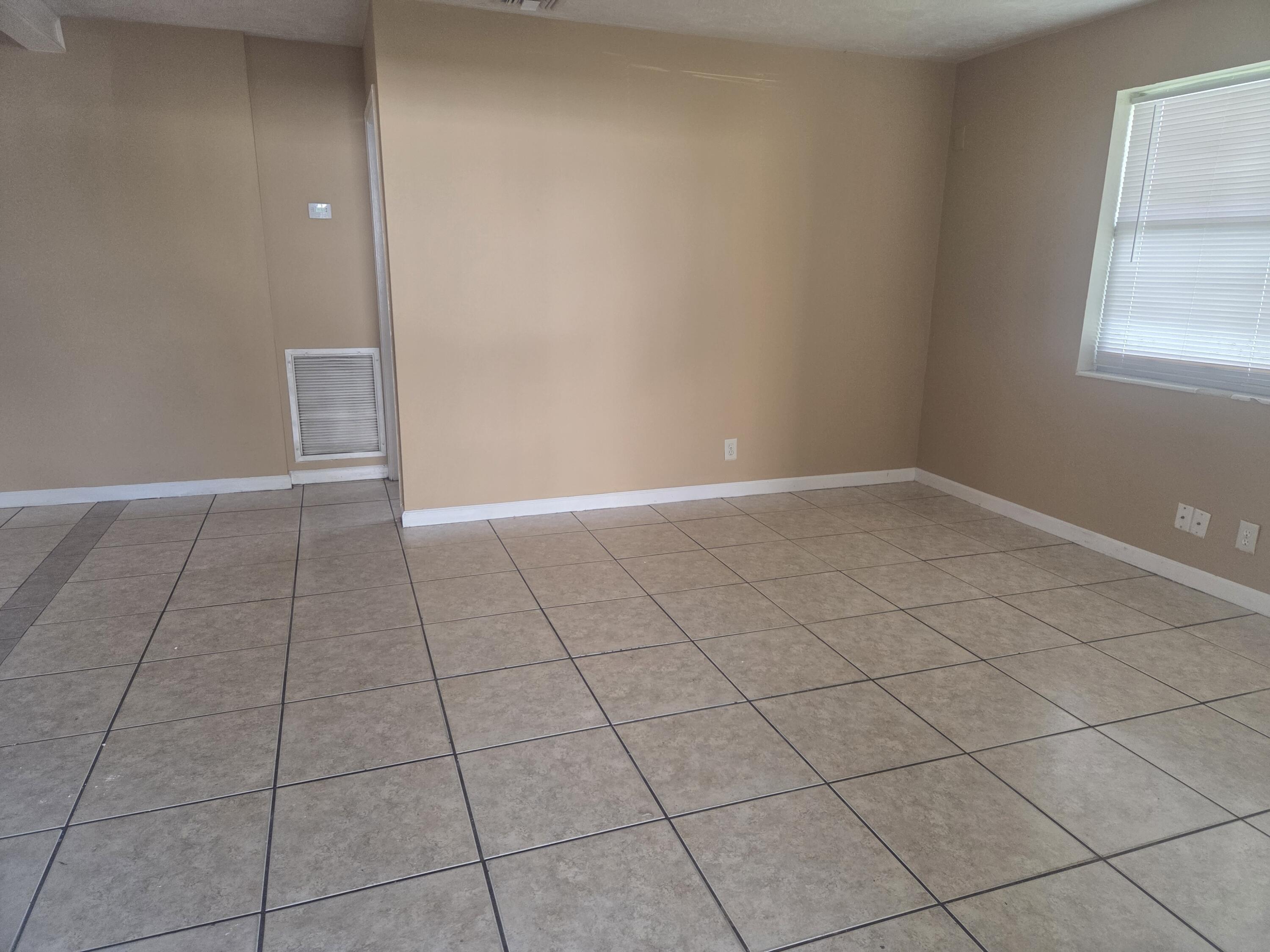 1509 Pine Tree Court Riviera Beach, FL 33404 - Photo 5 of 17 a view of an empty room and window