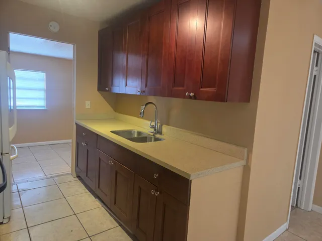 a kitchen with a sink cabinets and utility