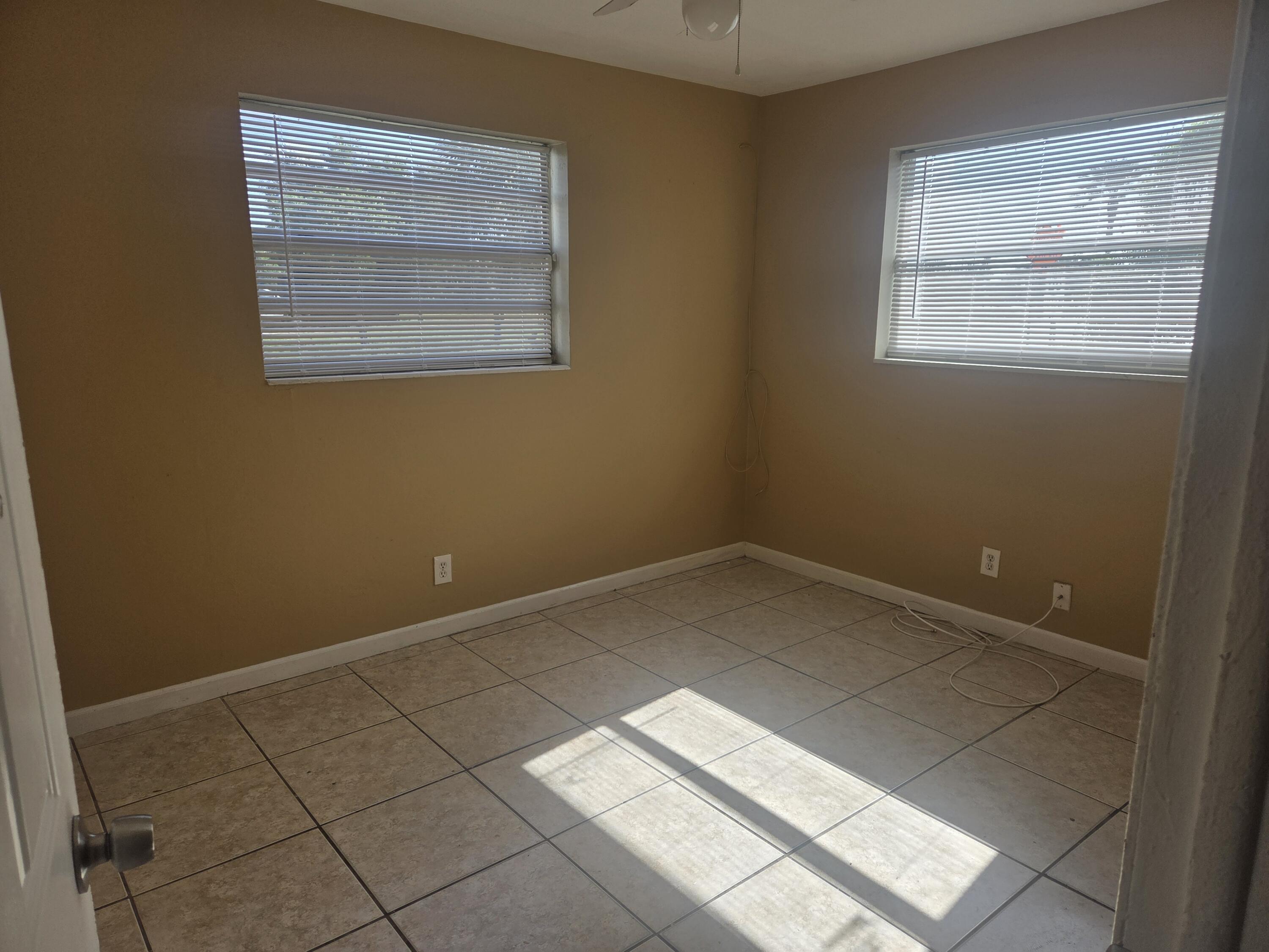 1509 Pine Tree Court Riviera Beach, FL 33404 - Photo 9 of 17 an empty room with a window