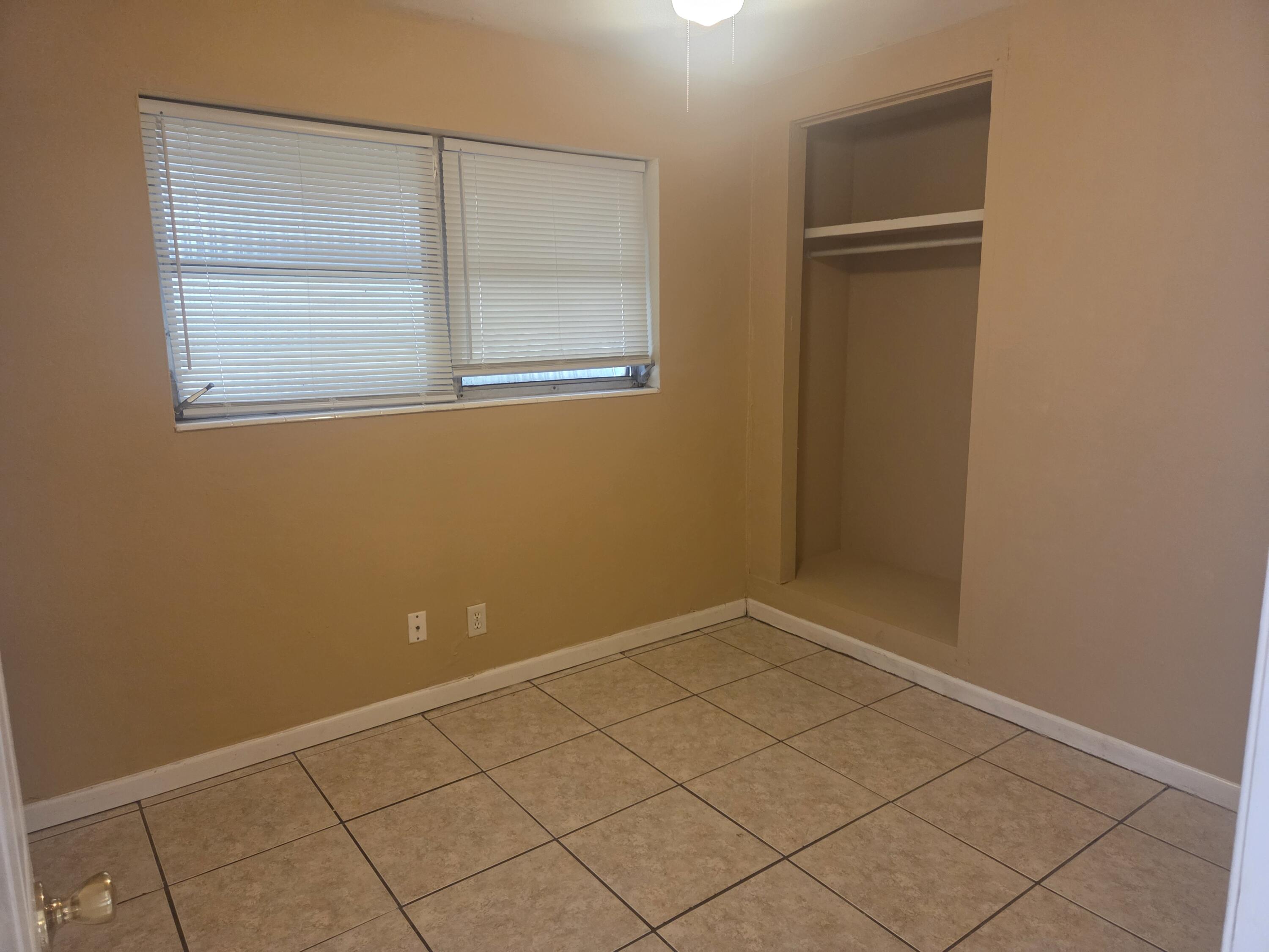 1509 Pine Tree Court Riviera Beach, FL 33404 - Photo 10 of 17 an empty room with a door
