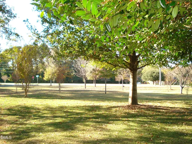 a view of a swimming pool with an outdoor seating and a yard