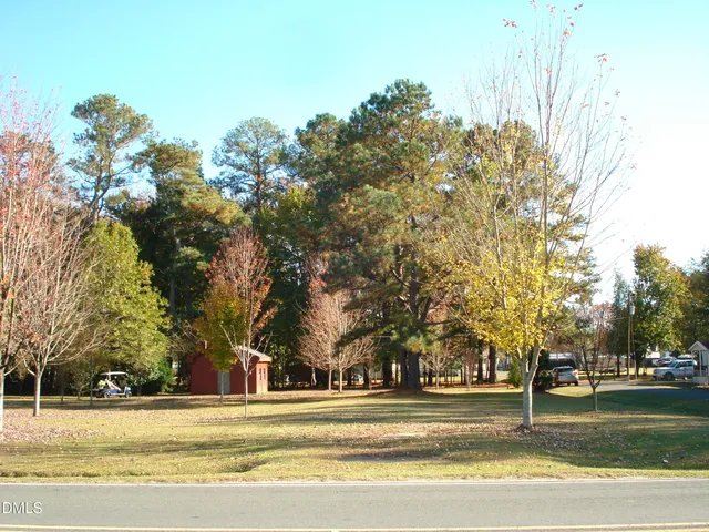 a view of a house with trees in the background