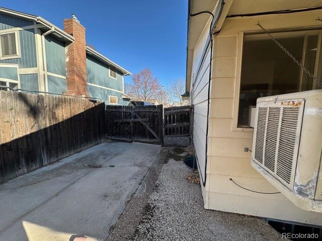 8191 Everett Way Arvada, CO 80005 - Photo 18 of 18 a view of house with a large window and wooden fence