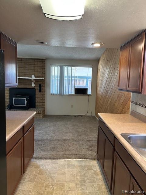8191 Everett Way Arvada, CO 80005 - Photo 5 of 18 a kitchen with stainless steel appliances granite countertop a sink and a stove