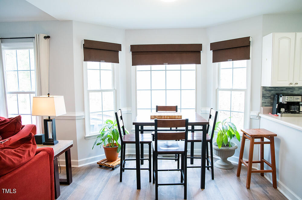 46 Beaver Crossing Road Roxboro, NC 27574 - Photo 11 of 50 a view of a dining room with furniture a potted plant and wooden floor