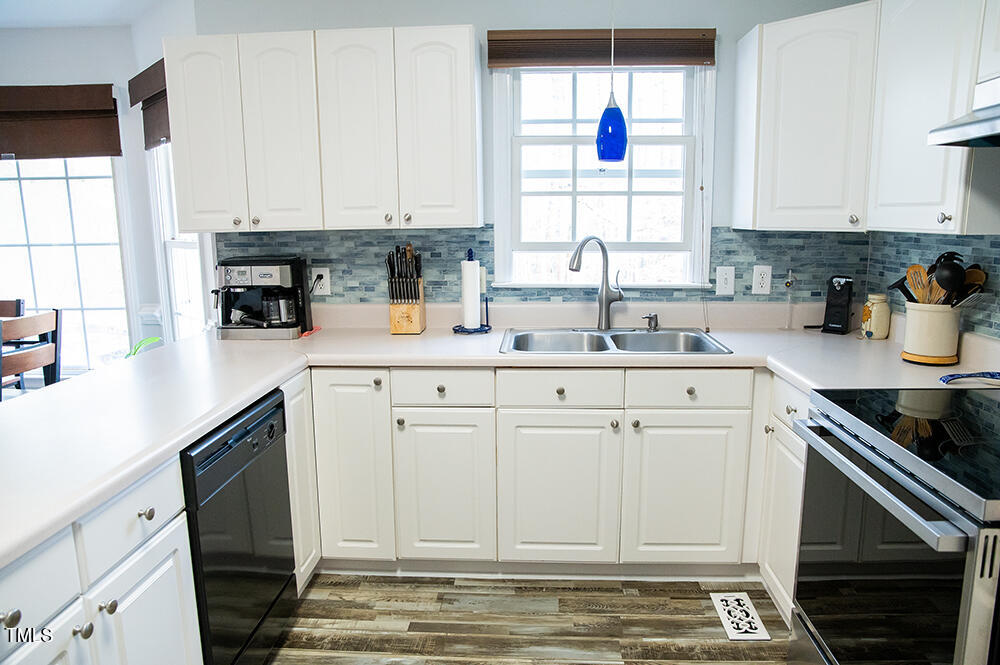 46 Beaver Crossing Road Roxboro, NC 27574 - Photo 15 of 50 a kitchen with granite countertop white cabinets and white appliances