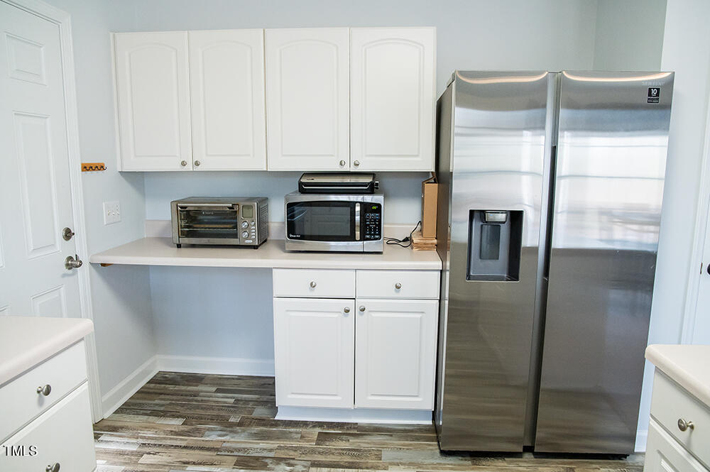 46 Beaver Crossing Road Roxboro, NC 27574 - Photo 16 of 50 a kitchen with stainless steel appliances white cabinets and a refrigerator