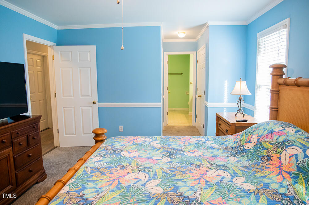 46 Beaver Crossing Road Roxboro, NC 27574 - Photo 20 of 50 a bedroom with a bed and a flat tv screen on dresser