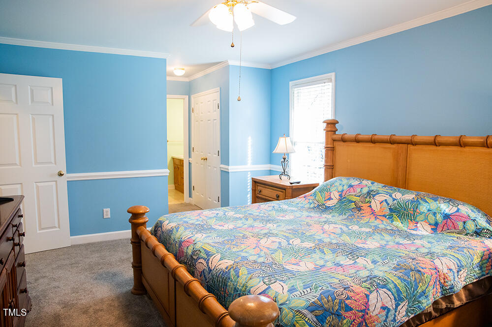 46 Beaver Crossing Road Roxboro, NC 27574 - Photo 22 of 50 a bedroom with a bed and a chandelier