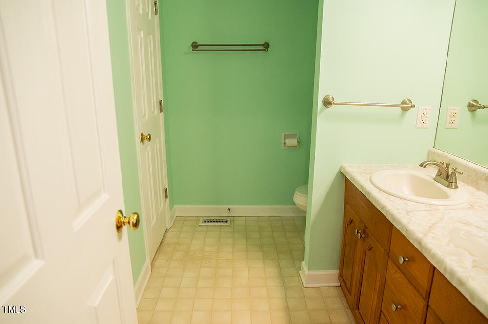 46 Beaver Crossing Road Roxboro, NC 27574 - Photo 27 of 50 a bathroom with a granite countertop sink a mirror and a bathtub