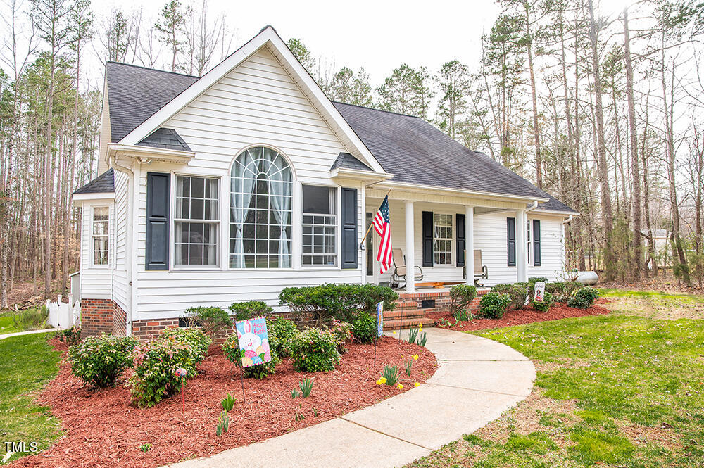 46 Beaver Crossing Road Roxboro, NC 27574 - Photo 33 of 50 a front view of a house with a yard and outdoor seating