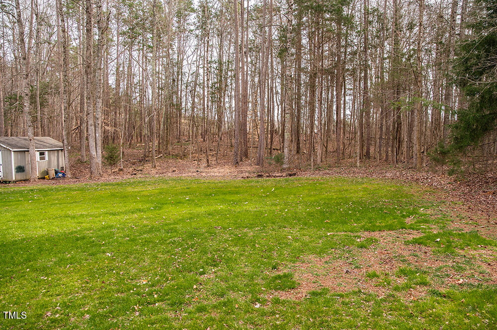 46 Beaver Crossing Road Roxboro, NC 27574 - Photo 38 of 50 a backyard of apartments with large trees