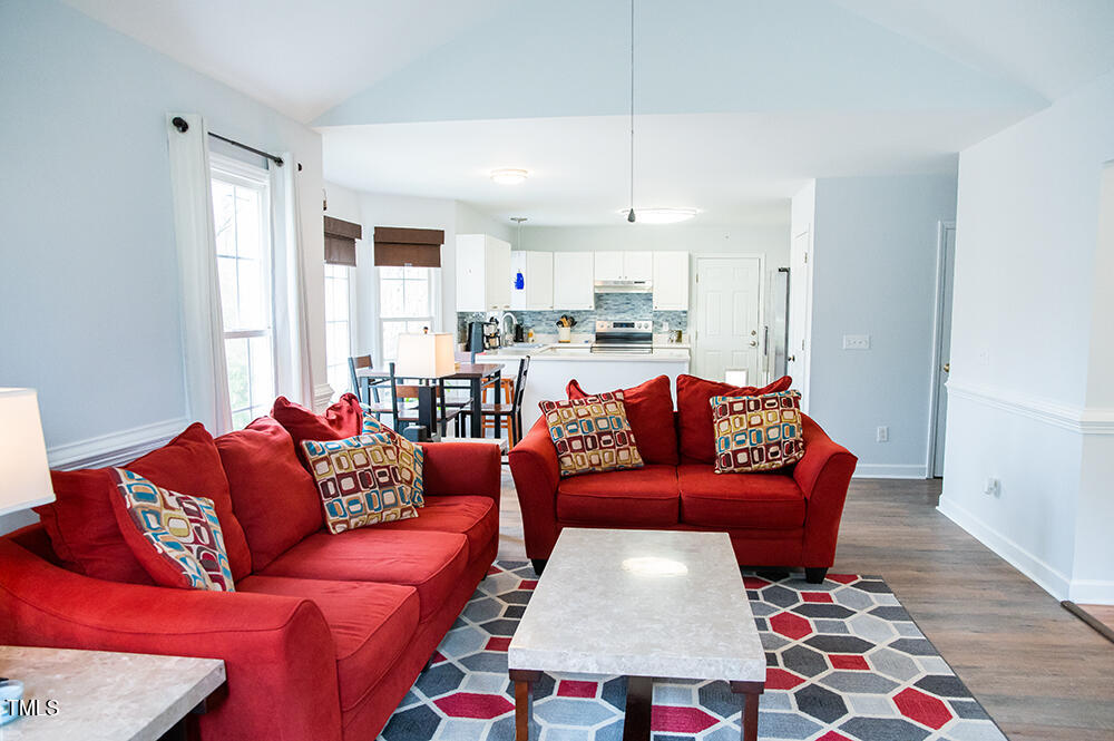 46 Beaver Crossing Road Roxboro, NC 27574 - Photo 8 of 50 a living room with furniture and a red lamp