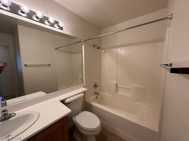 285 Spring Palms Street Henderson, NV 89012 - Photo 19 of 38 Bathroom with vanity, bathing tub / shower combination, toilet, a textured ceiling, and tile patterned floors