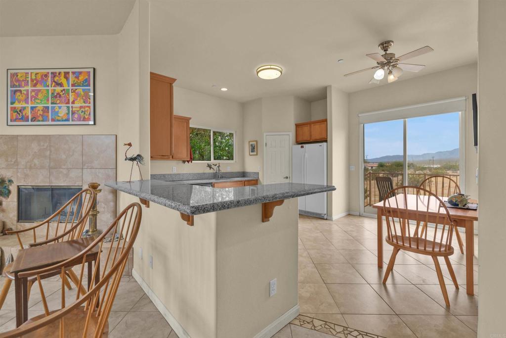 3431 Santa Saba Road Borrego Springs, CA 92004 - Photo 13 of 23 a view of a dining room with furniture and a floor to ceiling window