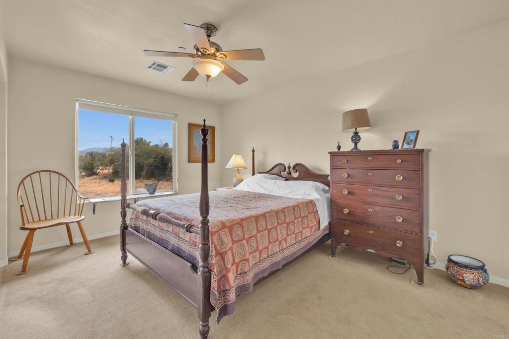 3431 Santa Saba Road Borrego Springs, CA 92004 - Photo 14 of 23 a bedroom with a large bed and a chandelier
