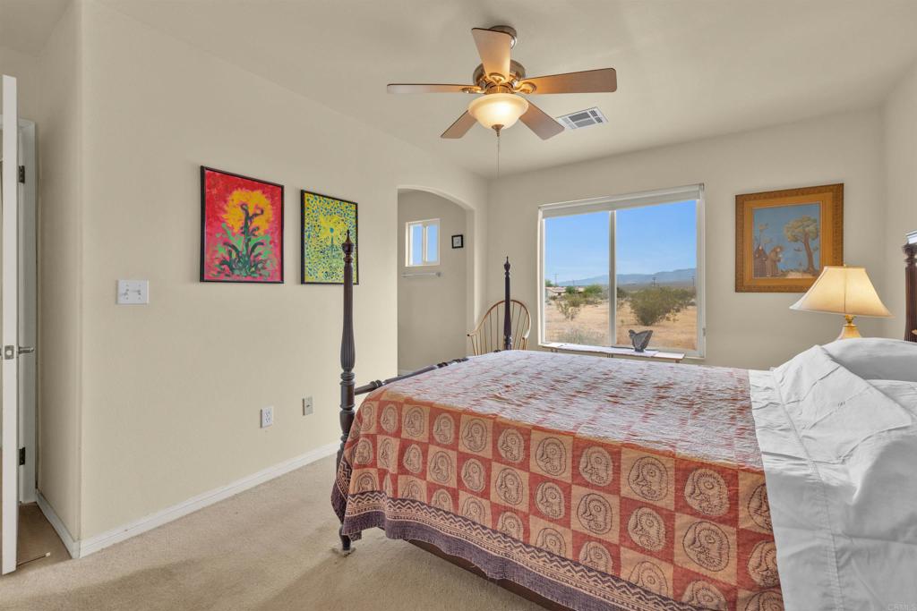 3431 Santa Saba Road Borrego Springs, CA 92004 - Photo 15 of 23 a bedroom with a bed and a chandelier