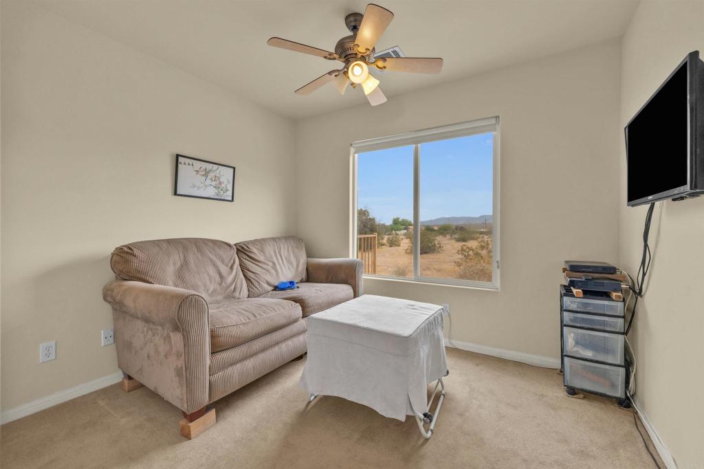 3431 Santa Saba Road Borrego Springs, CA 92004 - Photo 18 of 23 a living room with furniture a flat screen tv and a window