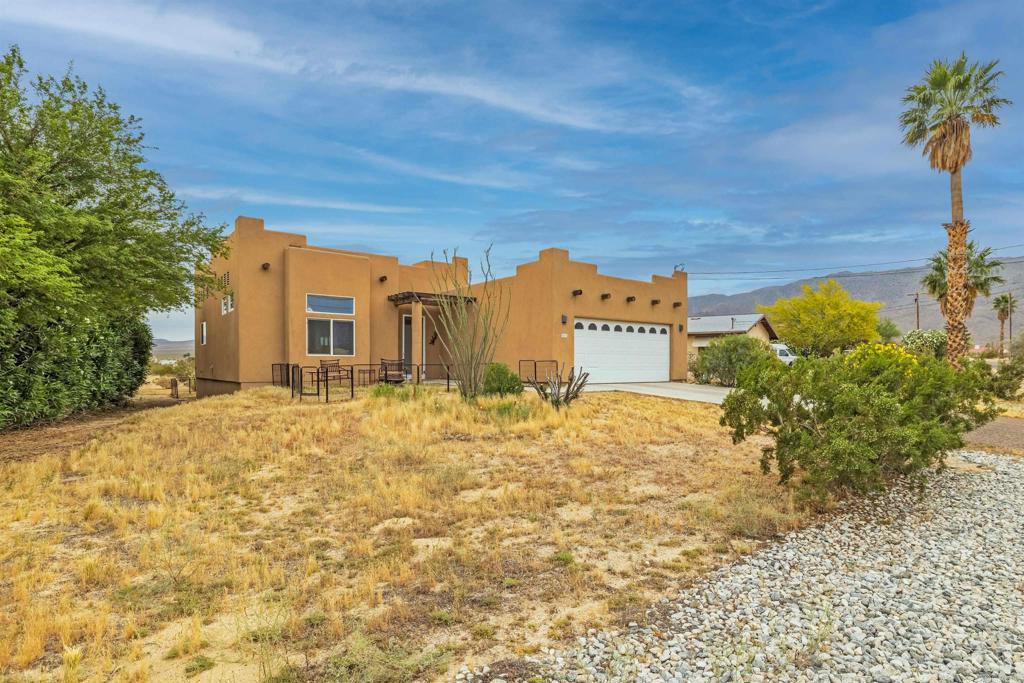 3431 Santa Saba Road Borrego Springs, CA 92004 - Photo 3 of 23 a front view of a house with a yard and garage